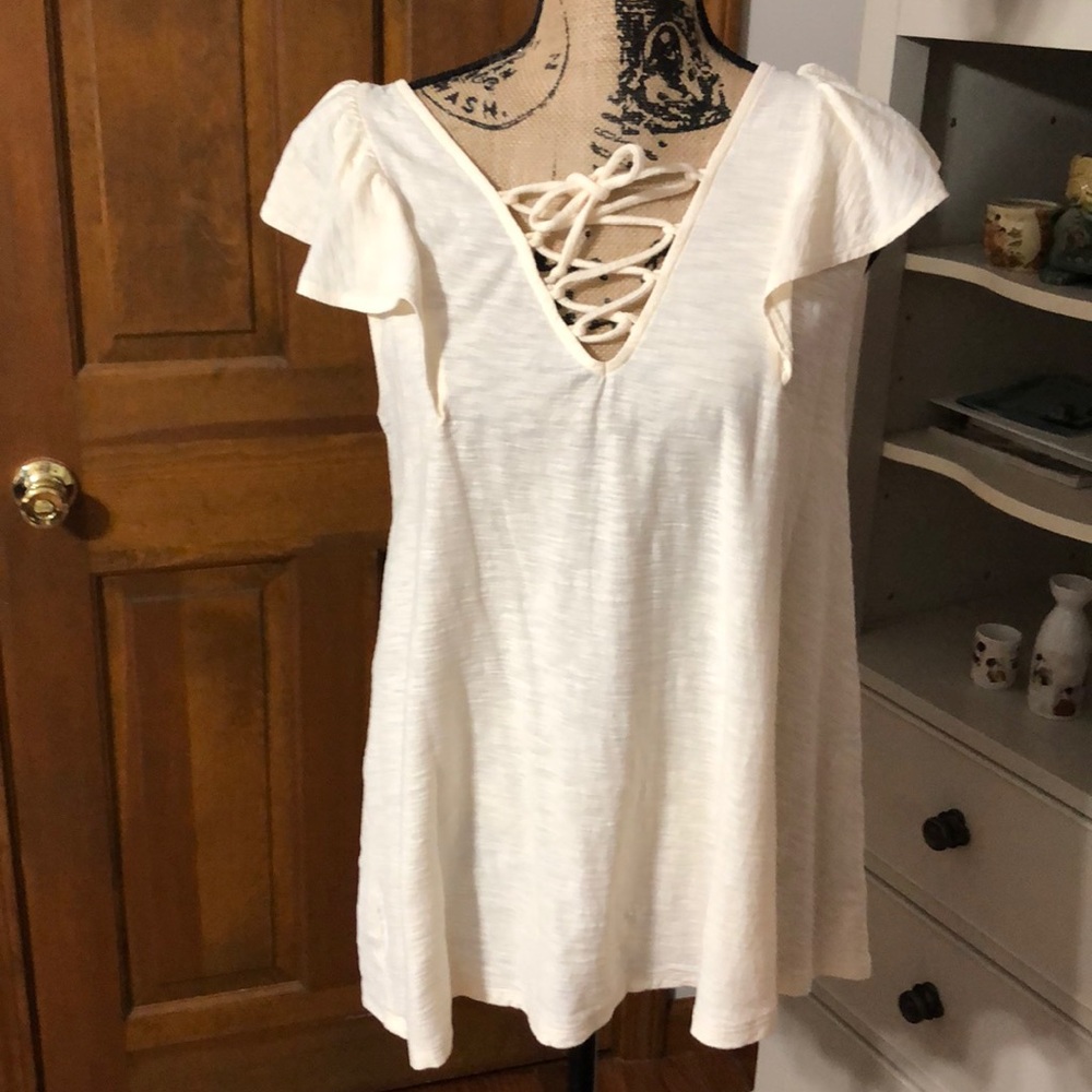 Cream colored crisscross tie detail in front Tunic